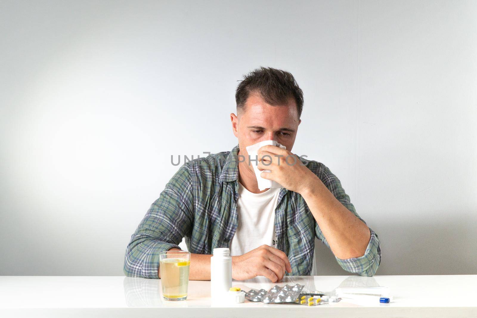 Runny nose in a man - home treatment for colds with pills and medications. High quality photo