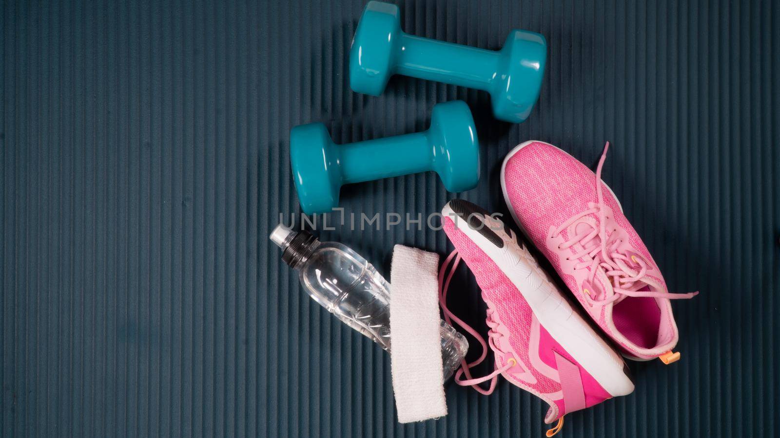 Gym workout kit - dumbbells with sneakers, bottle of water, towel and Buff. High quality photo