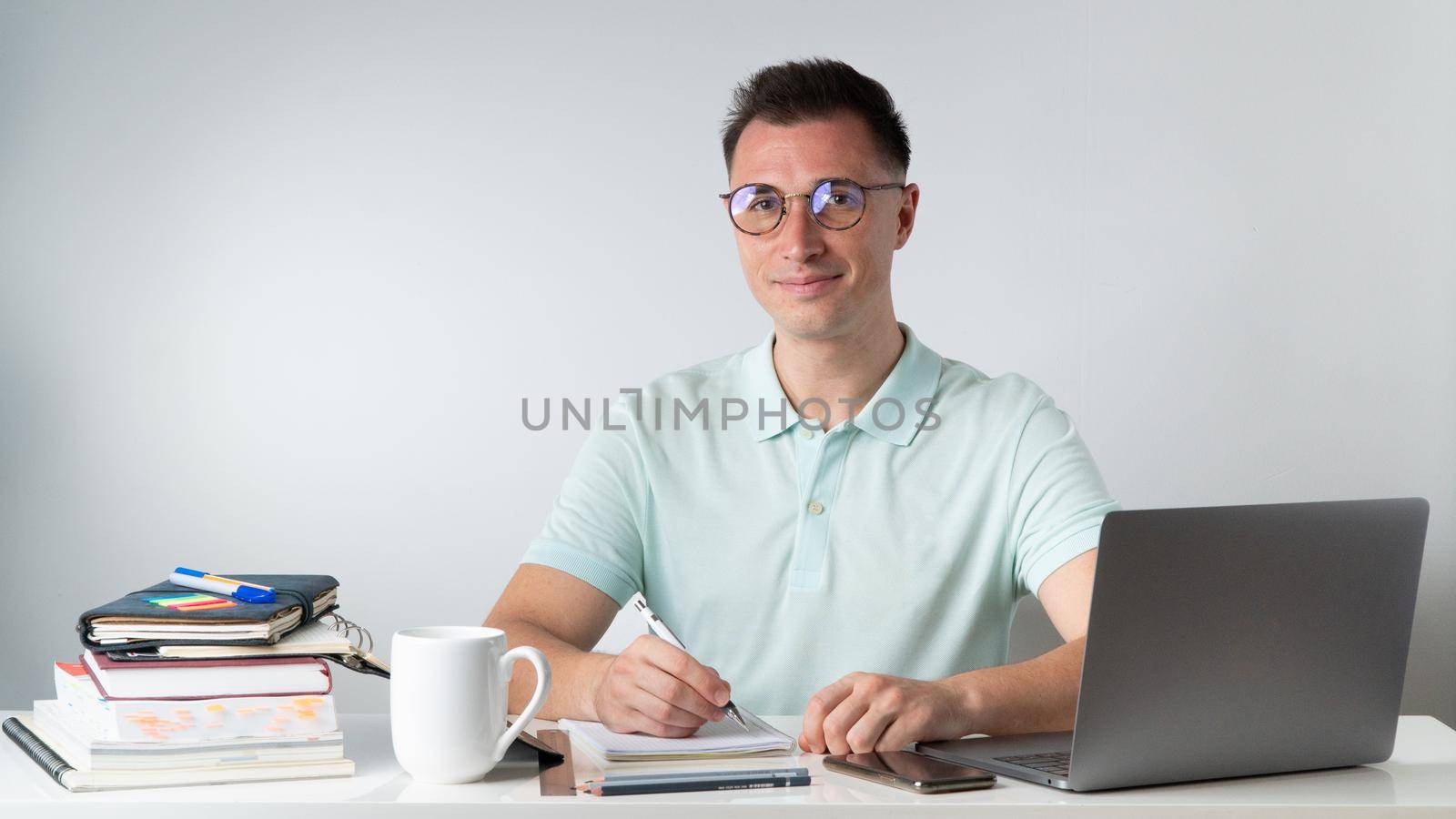 Training - the student at the table with books, notebooks, laptop. High quality photo