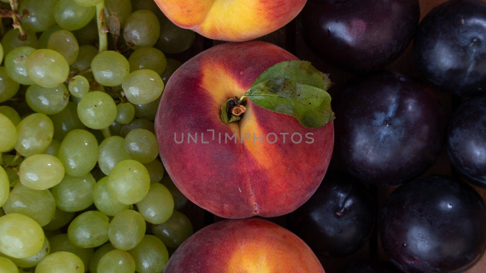 Grapes, peach and plum - fruit background close-up. High quality photo