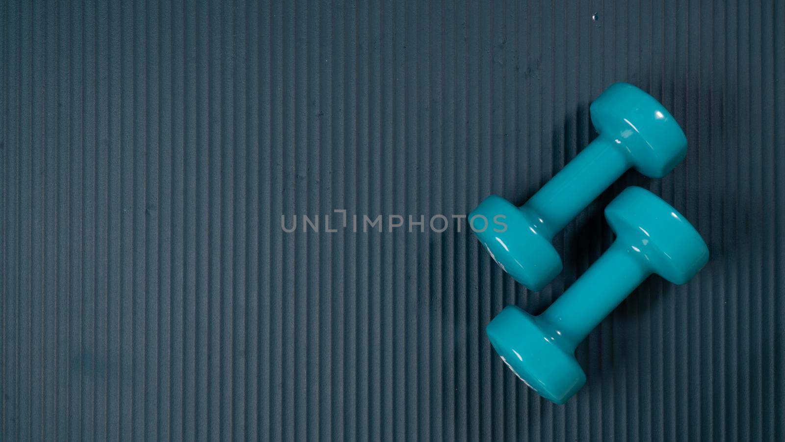 Two dumbbells on a sports mat with space for inscription by voktybre