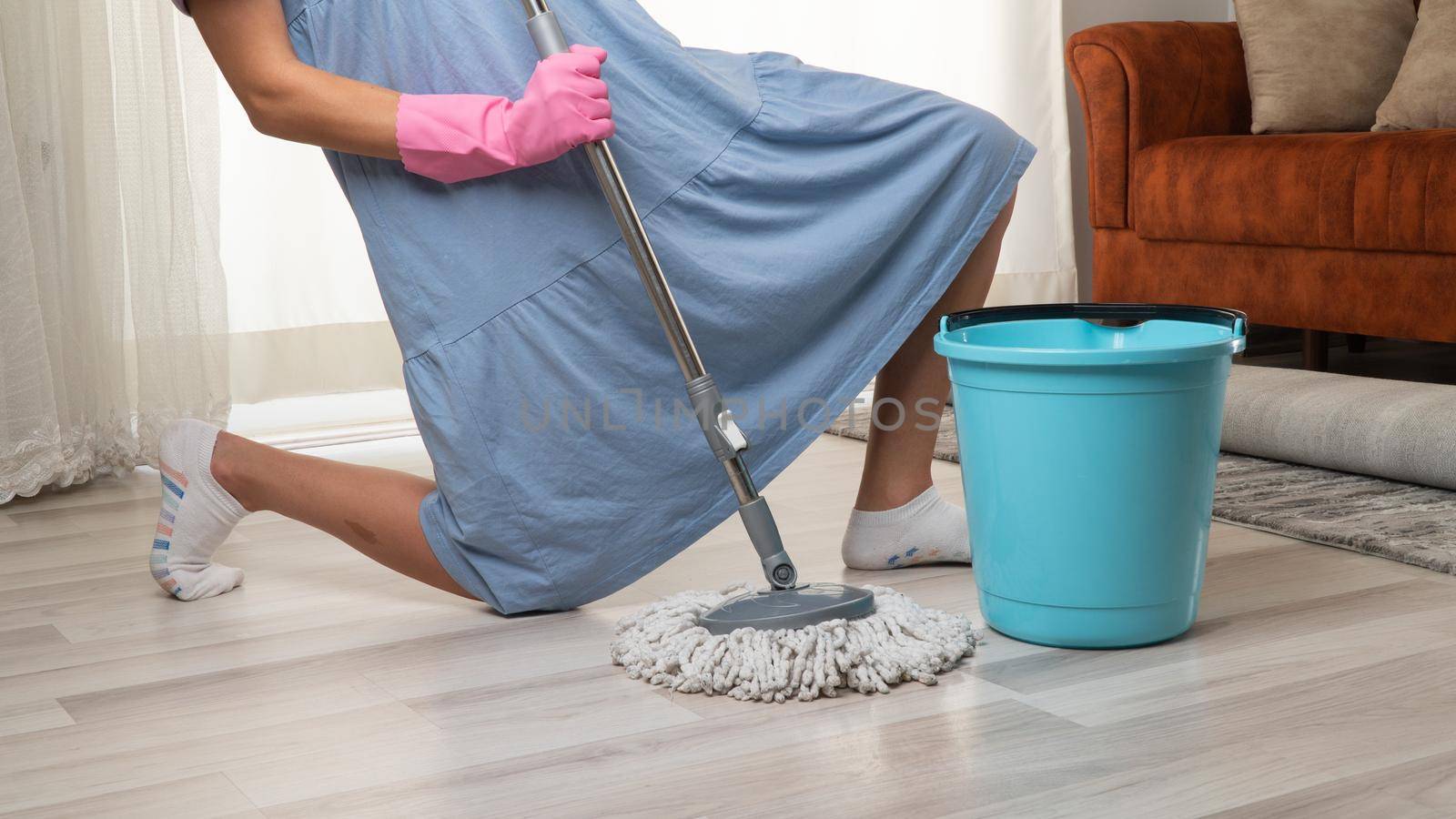 Woman with a mop and a bucket in the pose of a rock star by voktybre