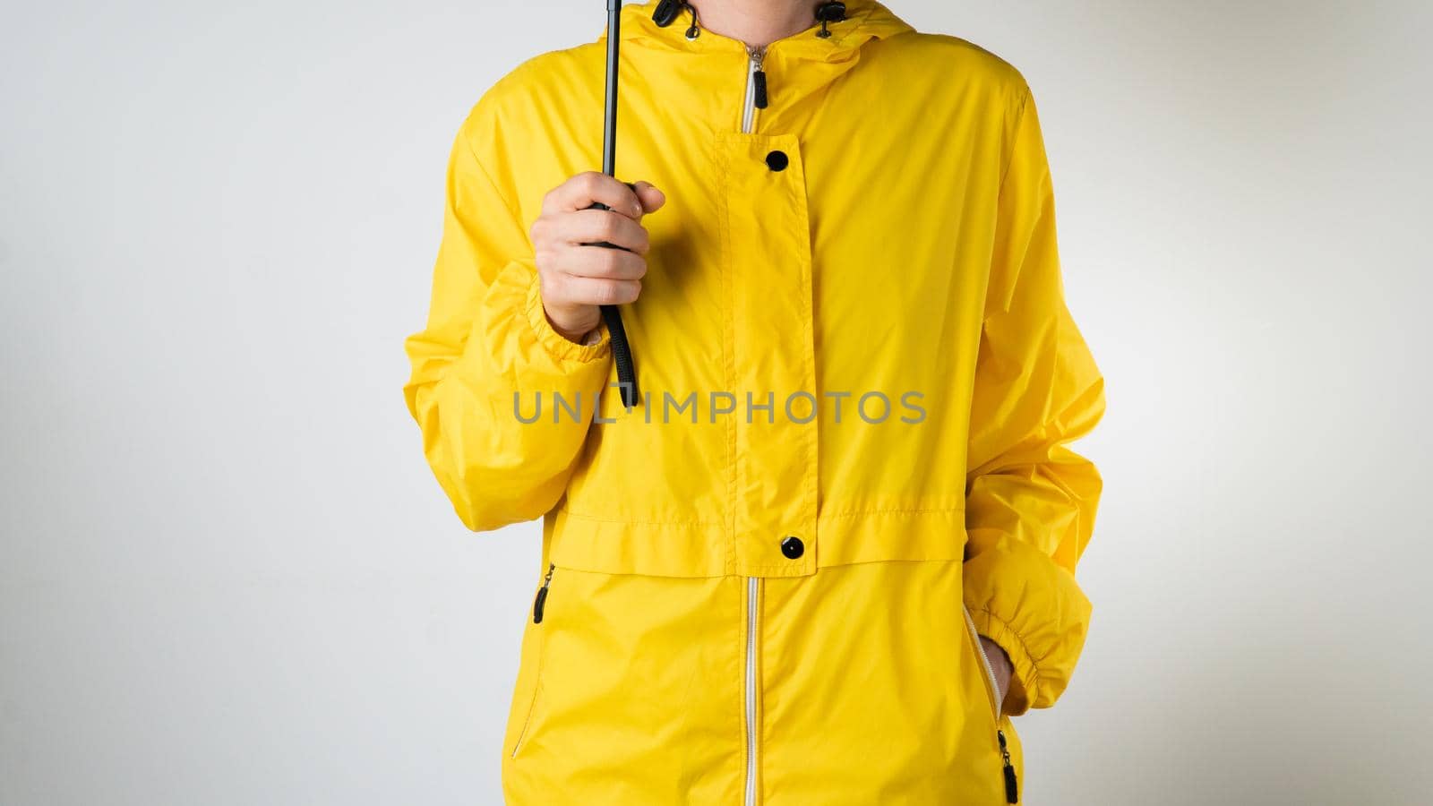A woman in a yellow raincoat holds a black umbrella on a white background by voktybre