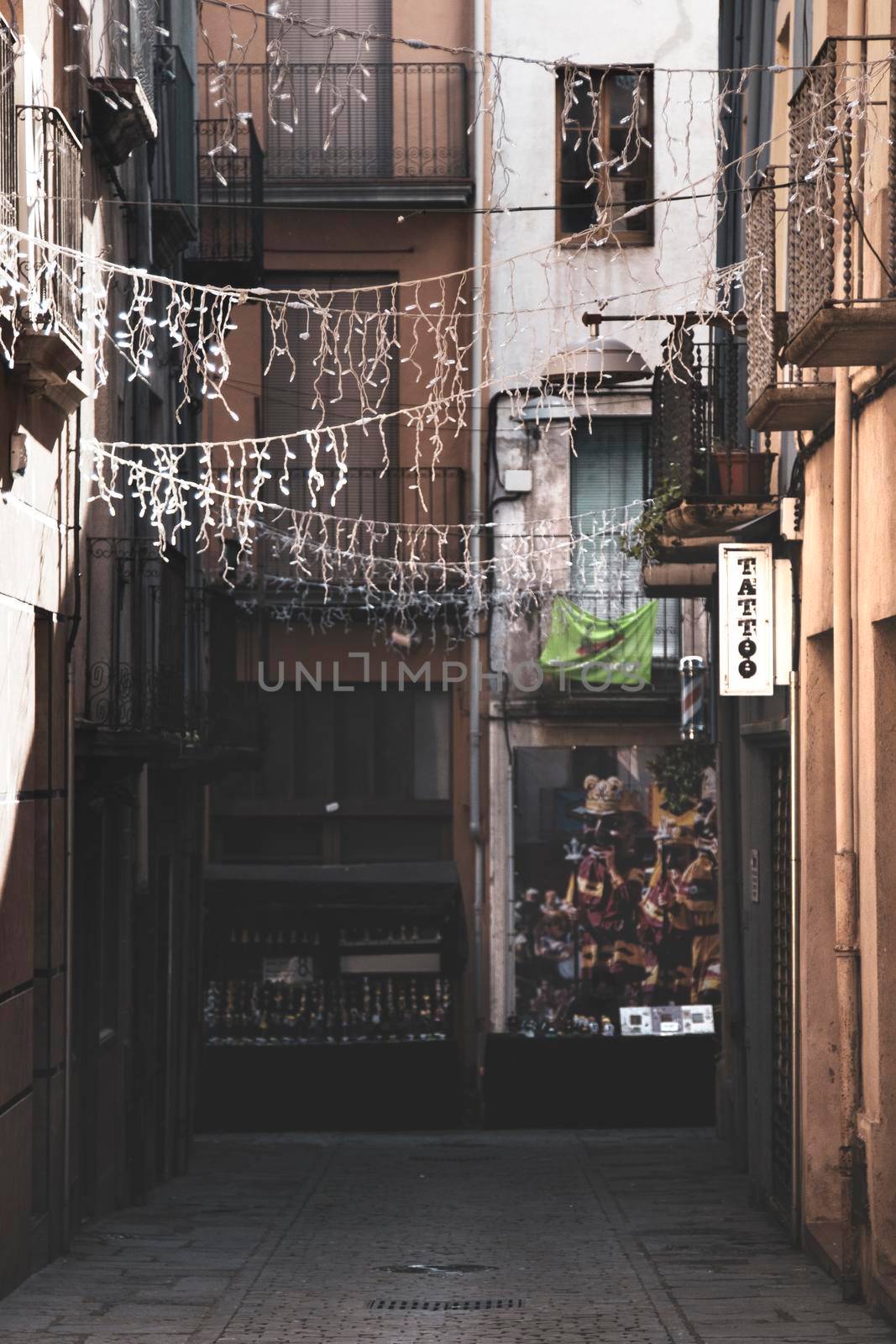 Commercial street in Olot Old town in Catalonia with Christmas decoration