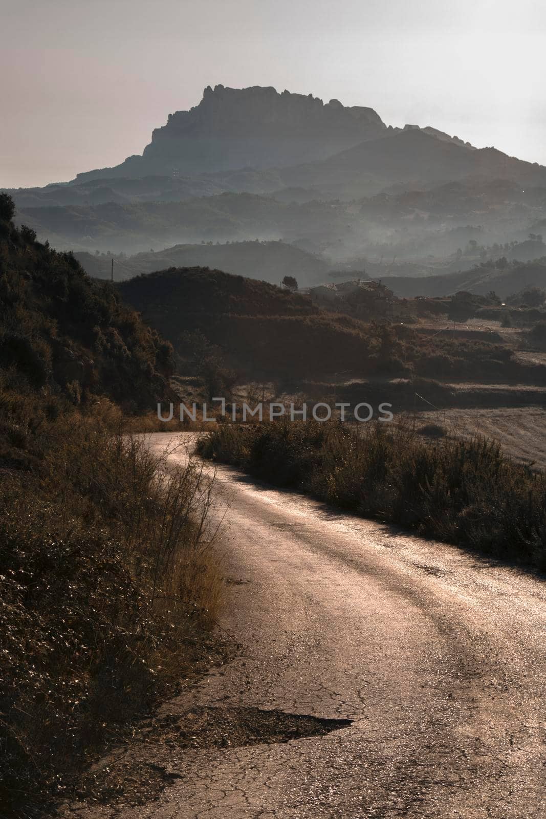 Landscape showing Montserrat mountain at the end of a path in a misty morning view