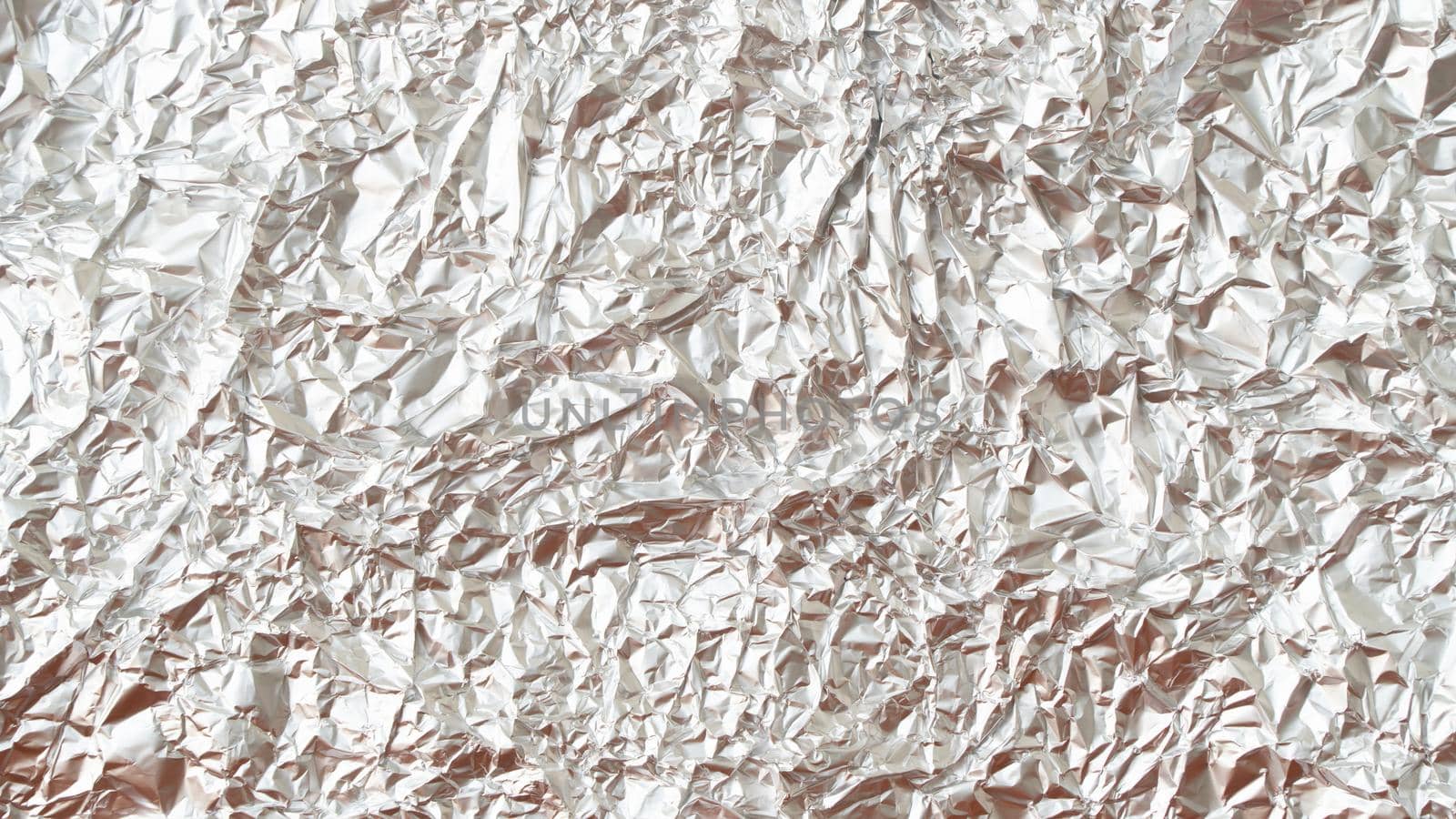 Rumpled foil texture background silver. High quality photo