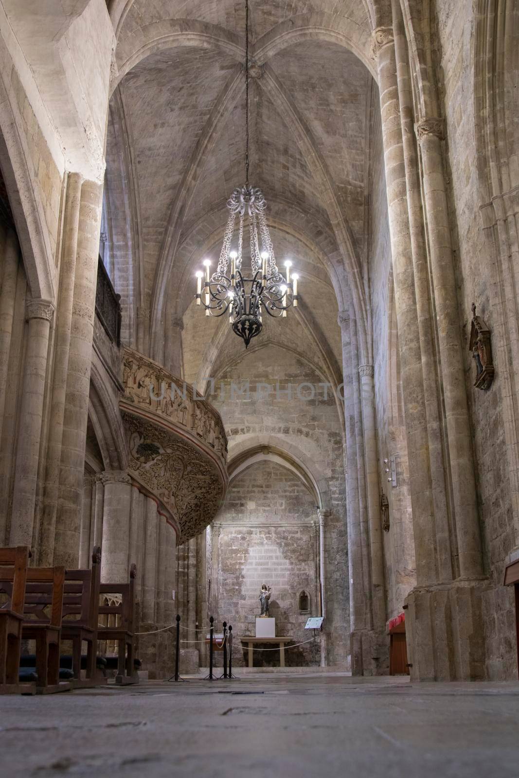 Interior view of a church showing a lamp and a balcony in the background