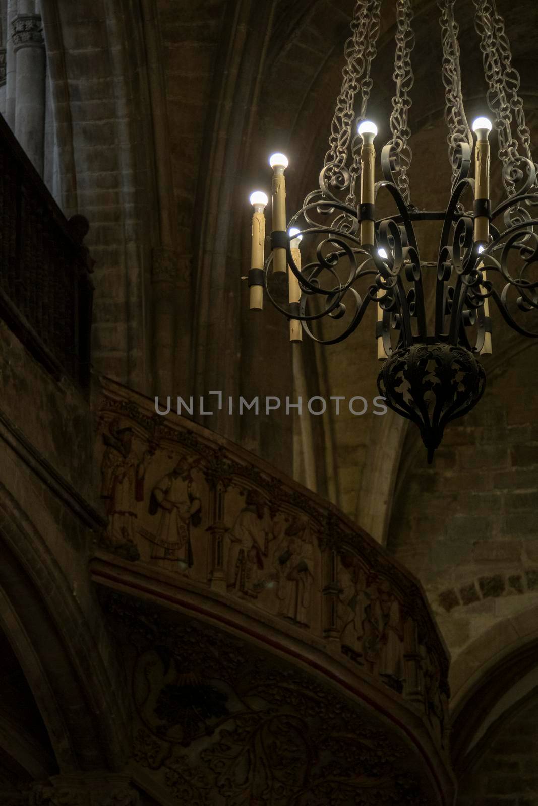 Interior view of a church showing a lamp and a balcony in the background