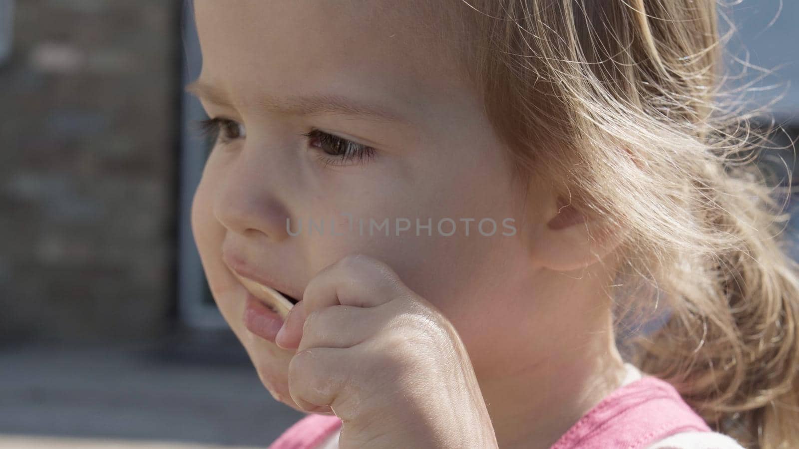 Close up portrait Girl enjoys delicious ice cream cone. Child eating watermelon popsicle. Kids Siblings snack sweets in Home Garden. Summer holiday Hot weather Sunny Day. Childhood, Food Candy Friends. by mytrykau