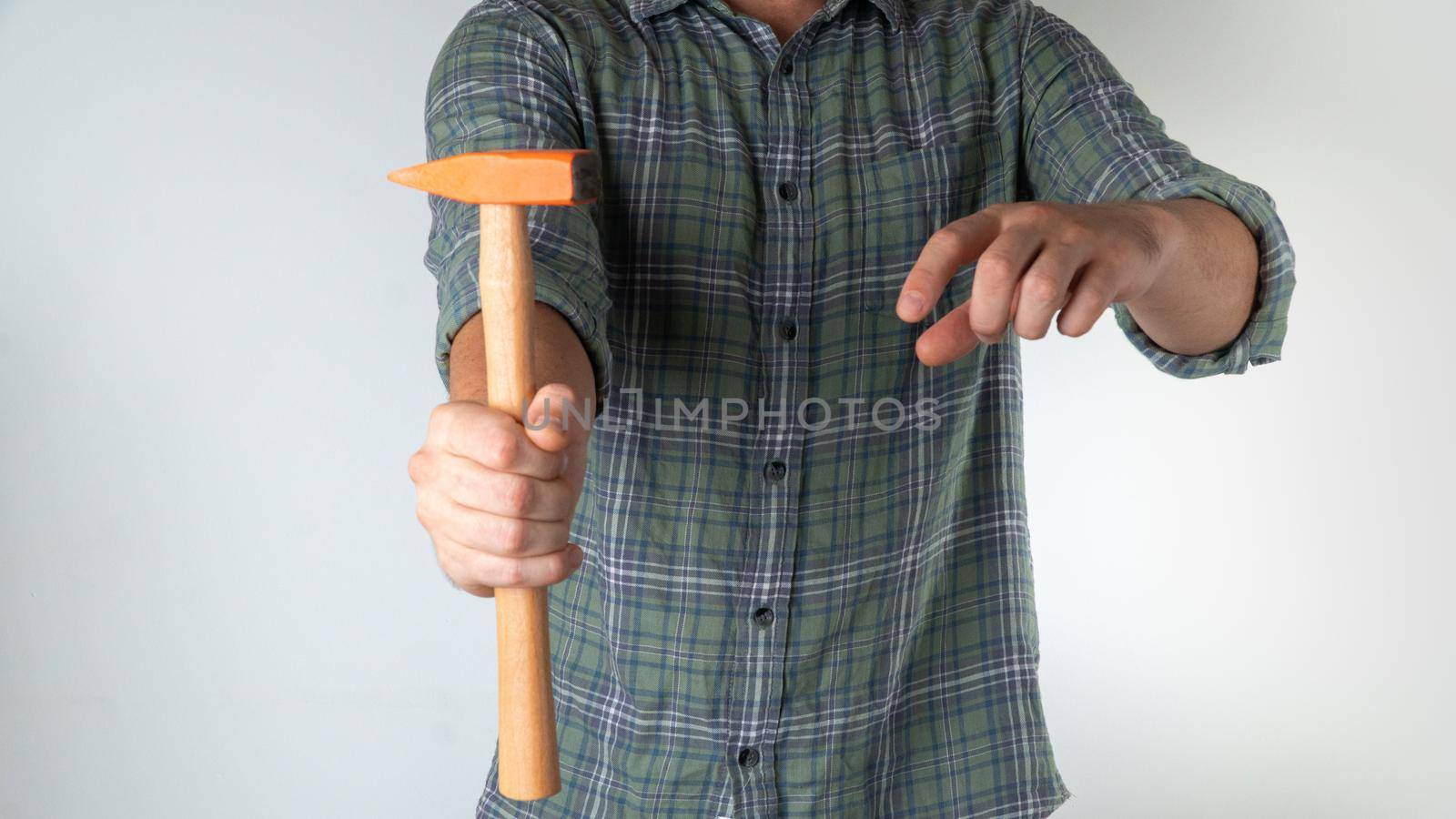 A man holds a hammer in his hand - home repairs. High quality photo