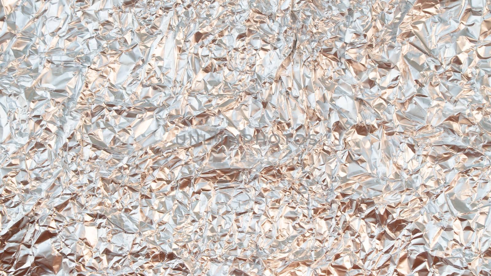 Rumpled foil texture background silver. High quality photo