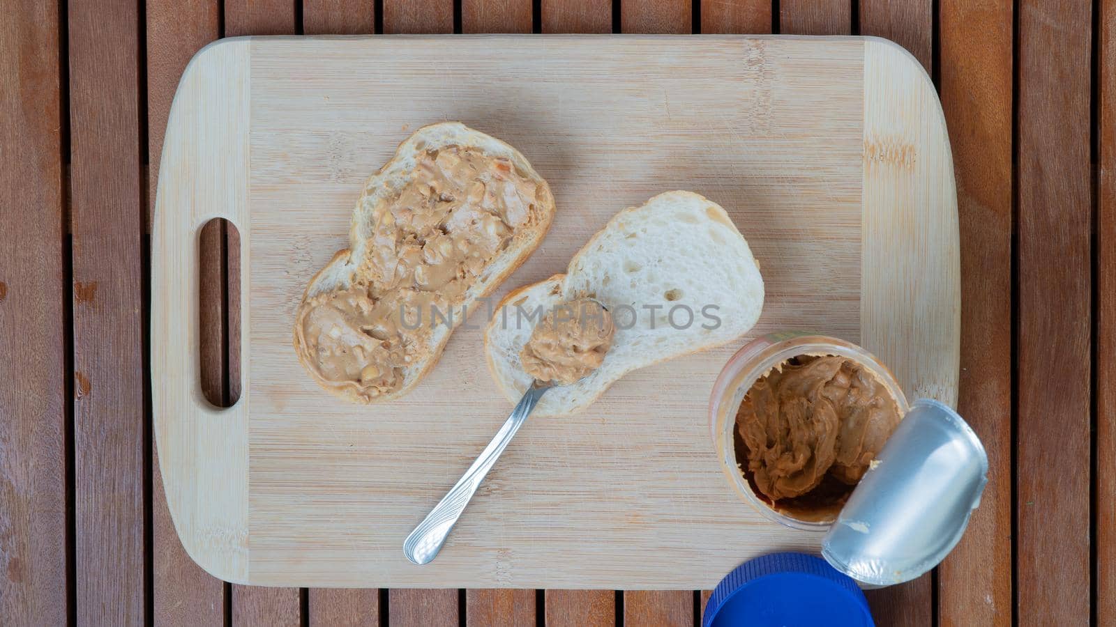 White bread sandwiches with peanut butter on a wooden background by voktybre