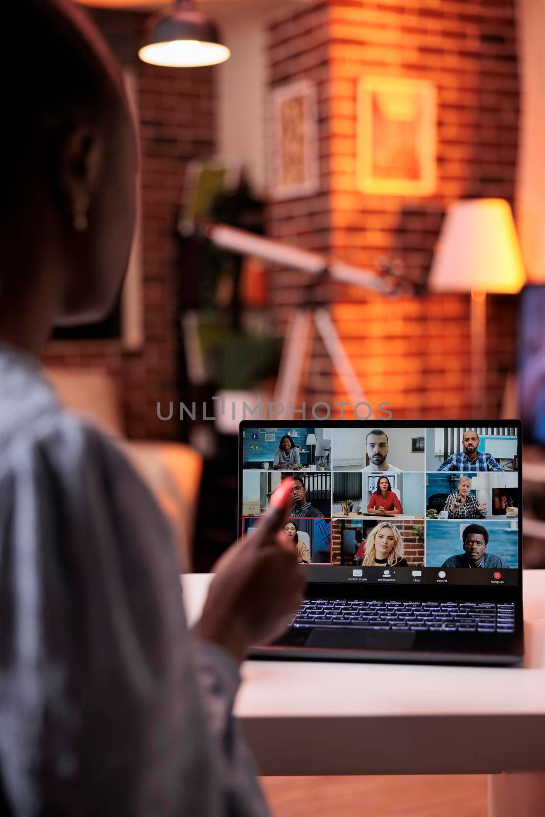 Businesswoman chatting with remote team on teleconference using laptop by DCStudio