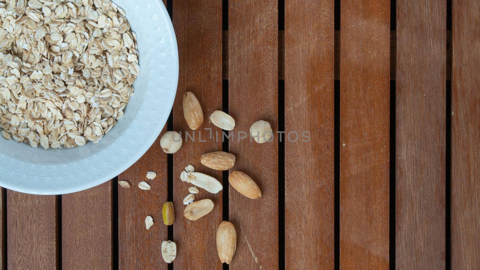 Oatmeal in a cup and nuts breakfast space for text by voktybre