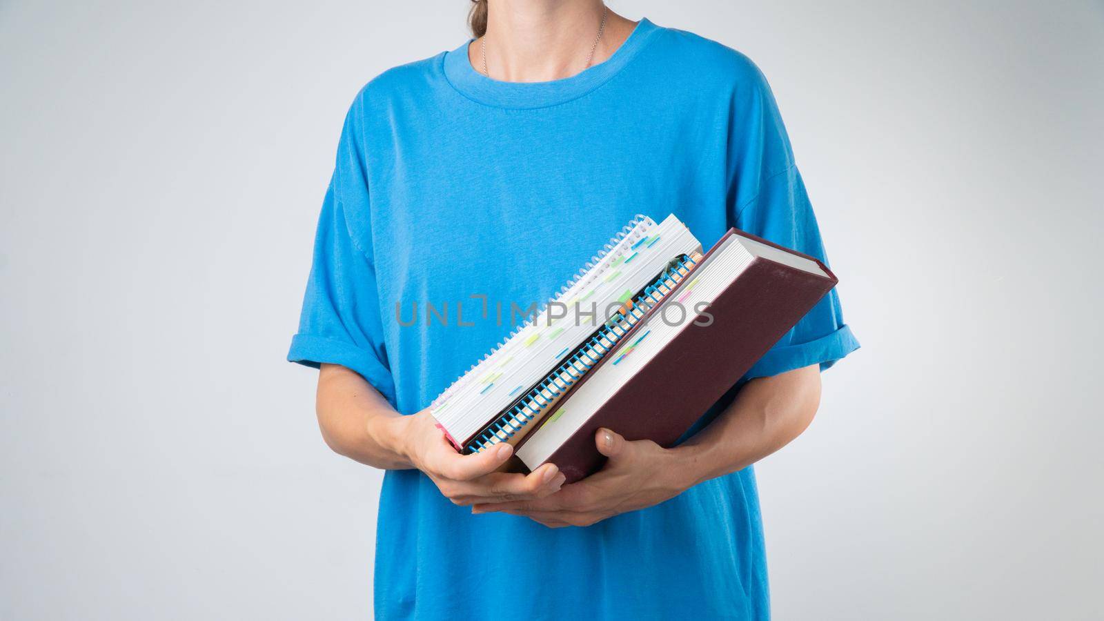 Subjects for study - a set of books, notebooks and notebooks in hand. High quality photo