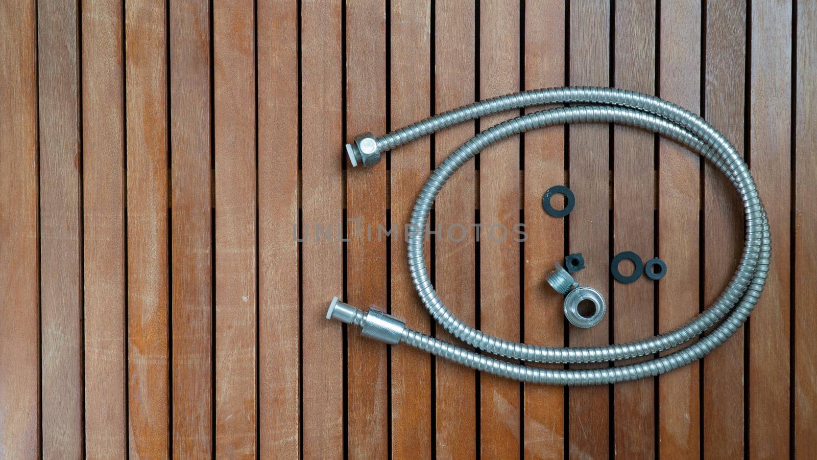 Hose and spare parts on wooden table background with space for text by voktybre
