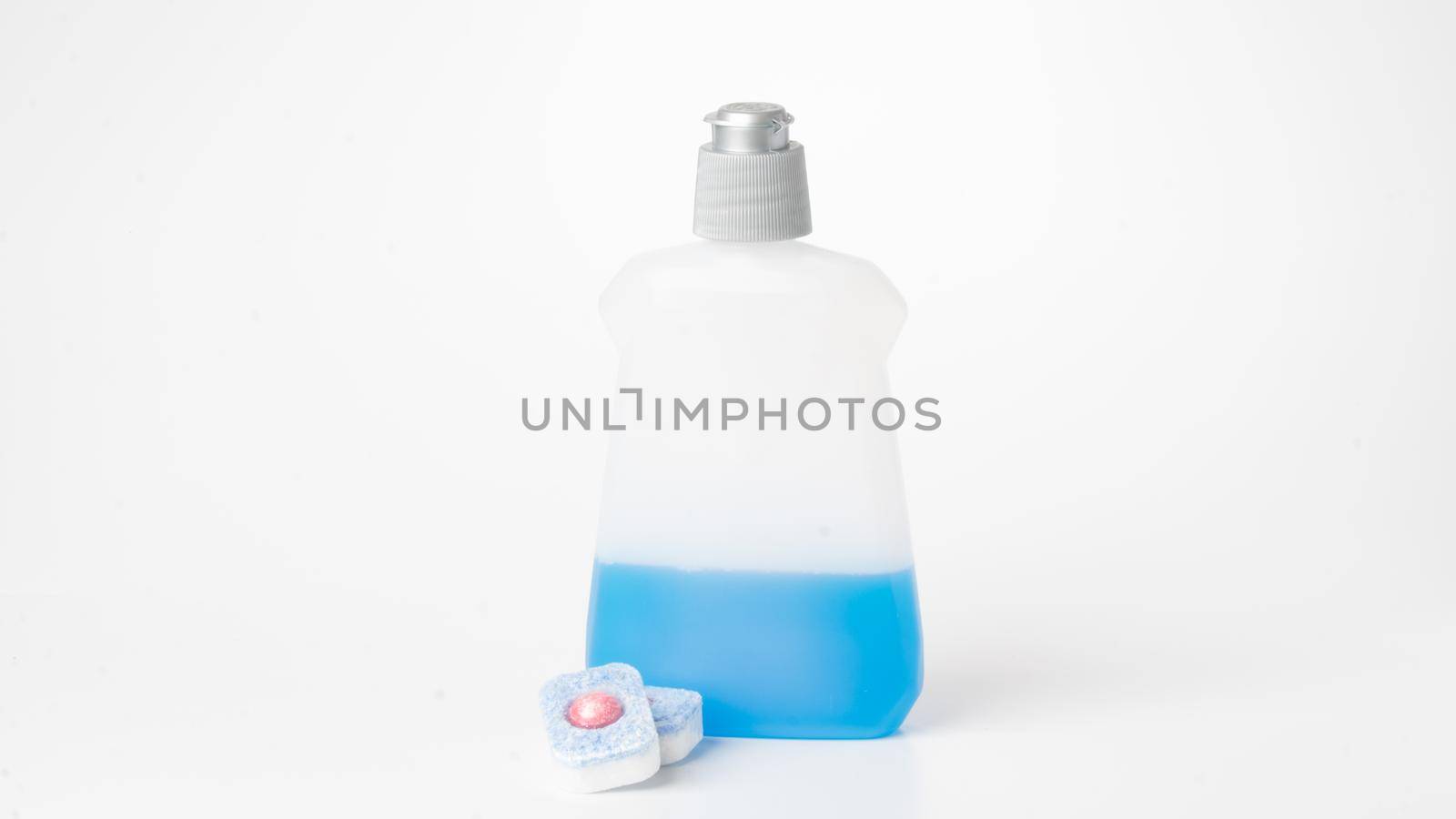 Detergent liquid and dishwasher tablets on a white background. High quality photo