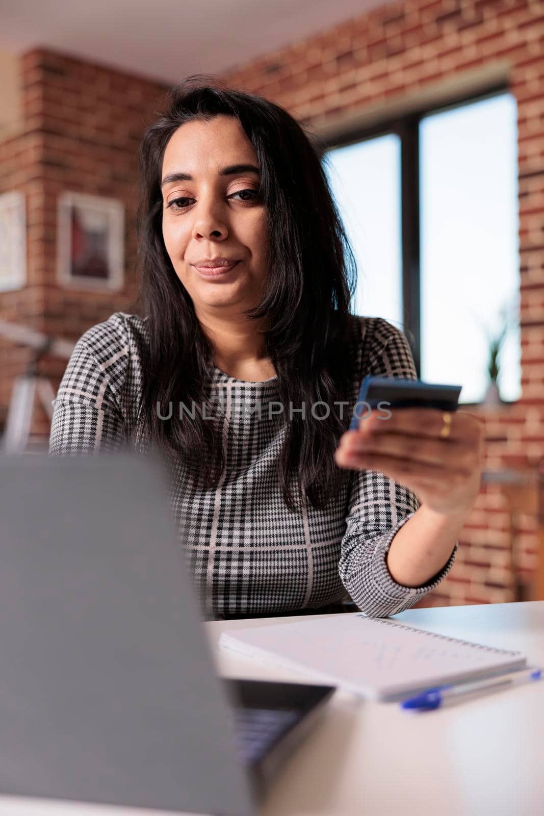 Indian woman making purchase online shopping on retail store website, using credit card to buy via electronic banking transaction. Paying on internet network, sale discount shop.