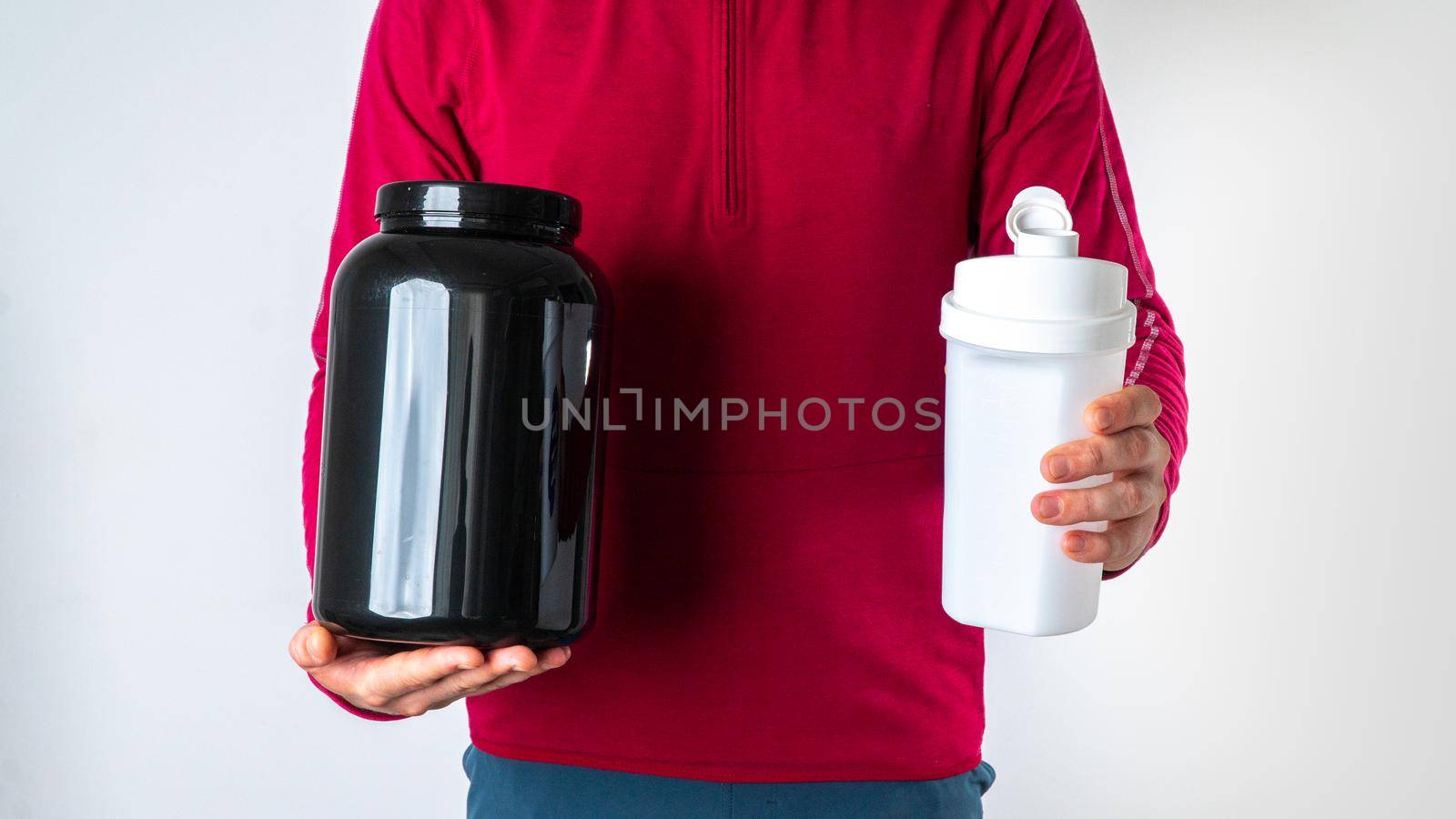 Athletic man with a protein can and shaker on a white background by voktybre