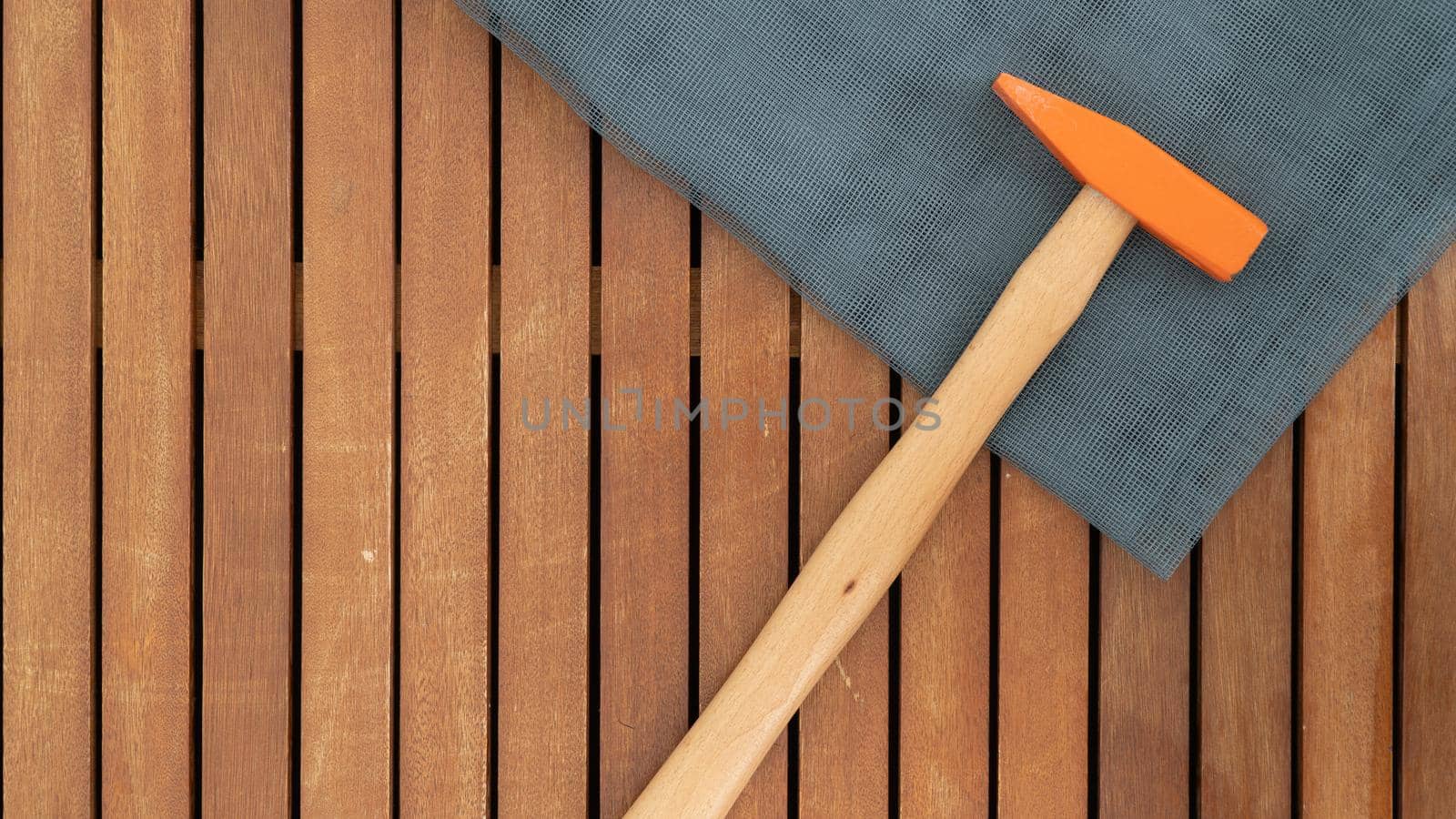 Hammer and construction grid on wooden background place for text by voktybre