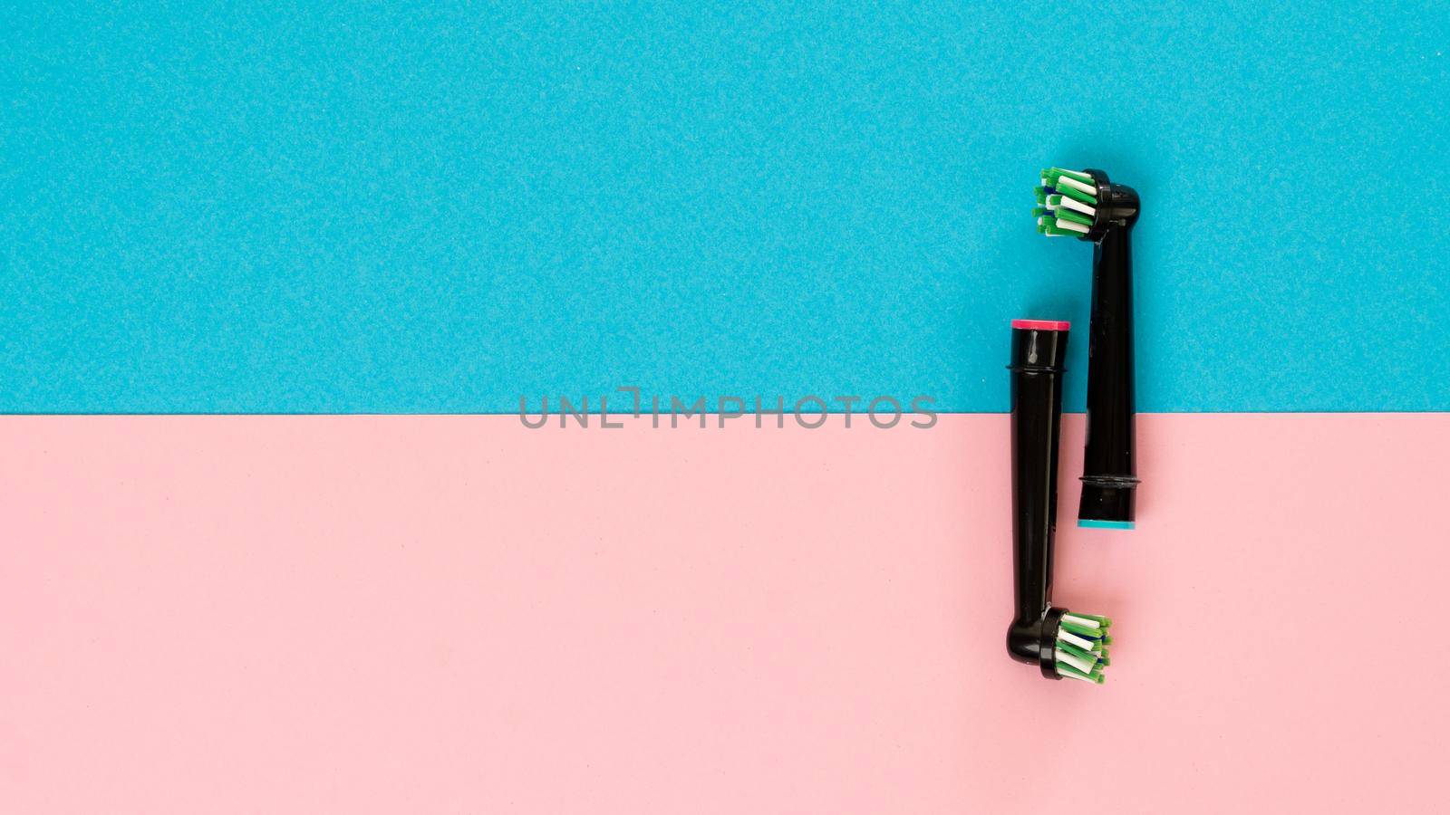 Electric toothbrush attachments on a two-tone background. High quality photo