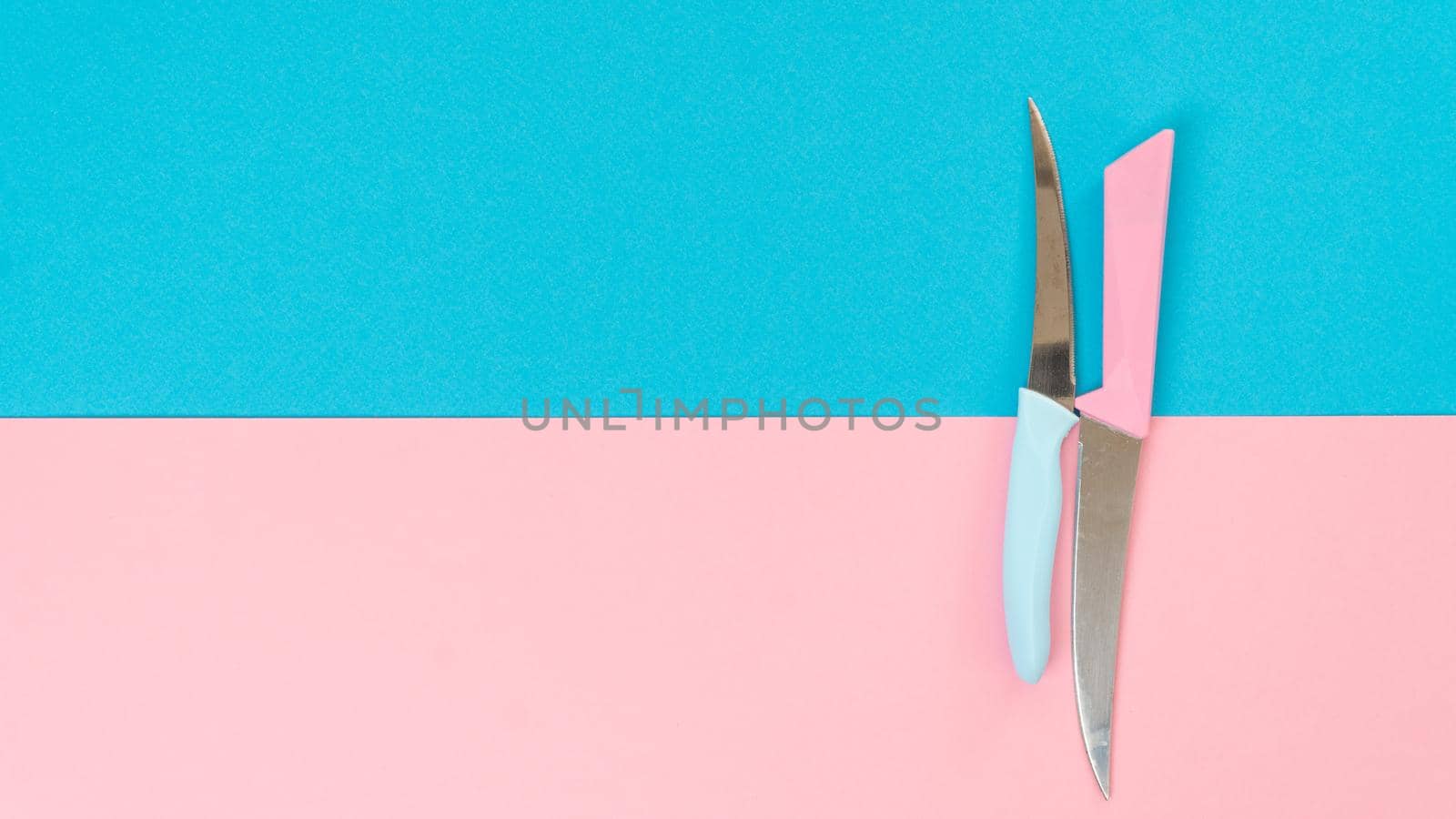 Composition of two colors - knives on a two-tone background. High quality photo
