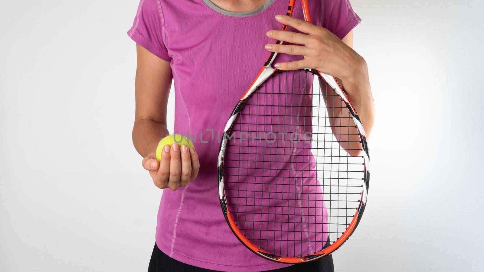 Sporty woman with tennis racket and ball on a white background. High quality photo
