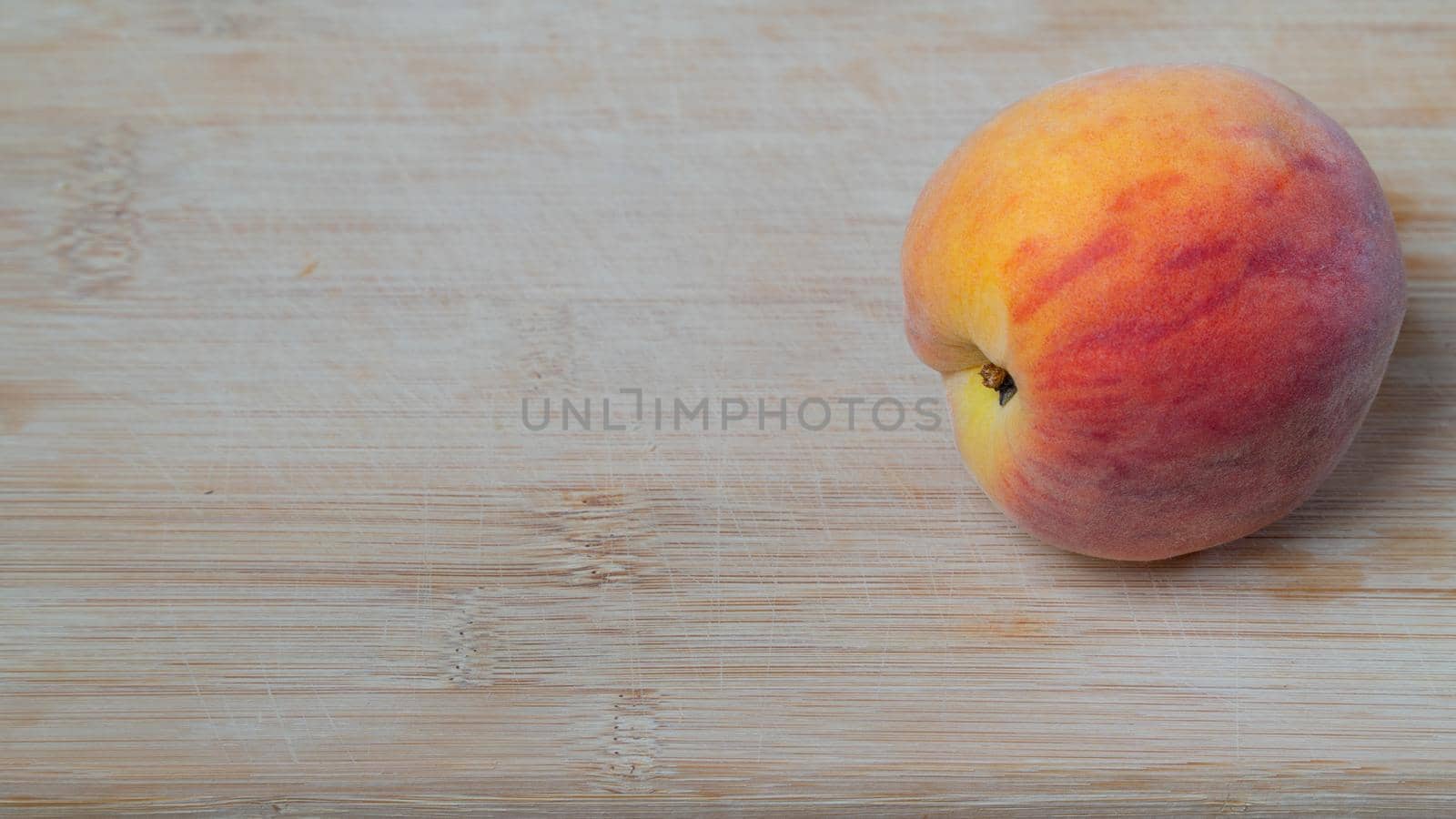 Peach fruit on a wooden background with space for text by voktybre