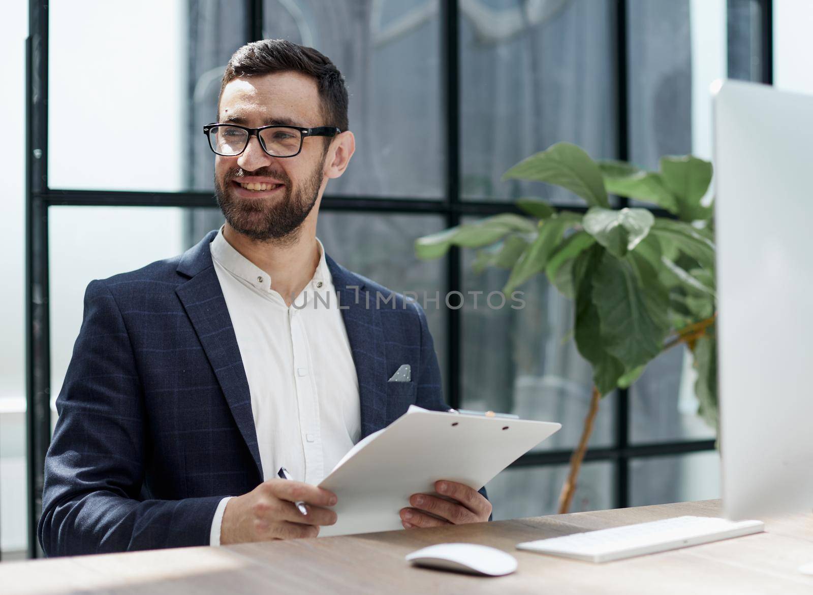 Close up view left-handed businessman writing in notebook in the office