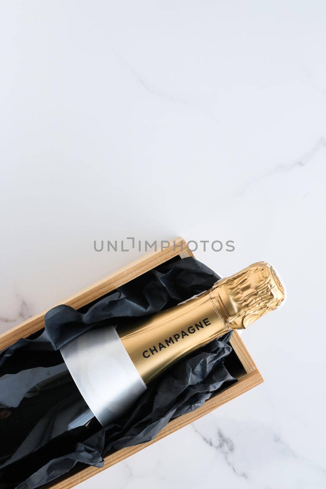 Wedding celebration, lifestyle and luxury present concept - A champagne bottle and a gift box on marble