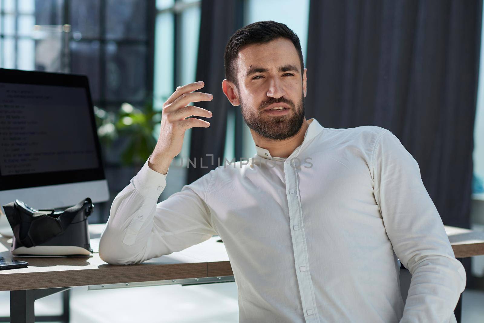 cheerful businessman in office looking at camera copy space