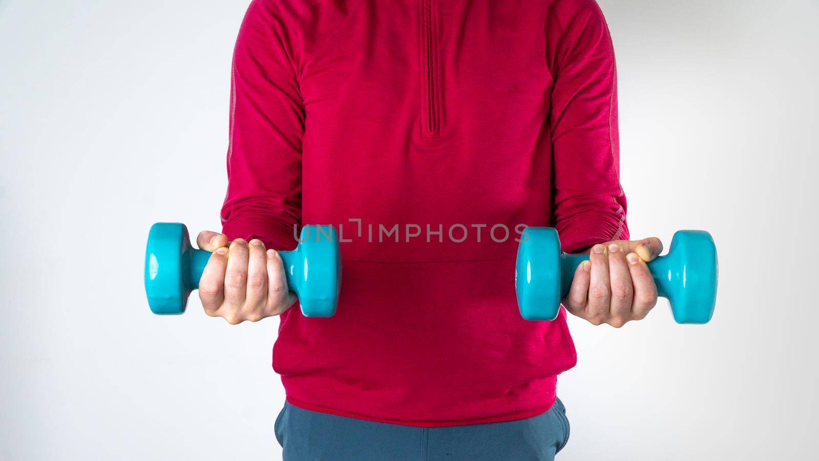 Athletic man with dumbbells in his hands for training. High quality photo