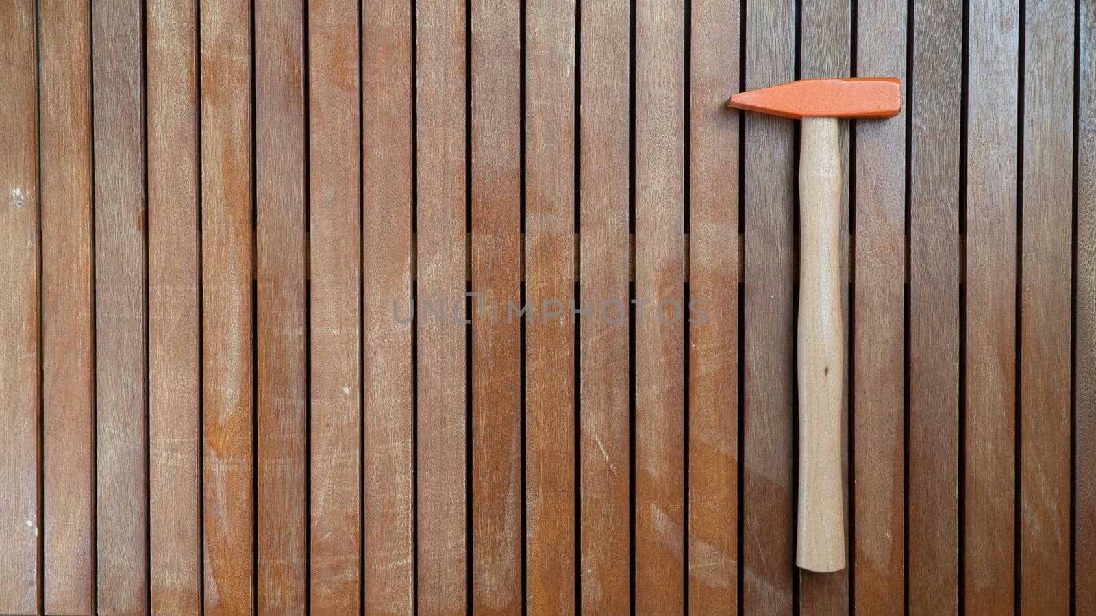 Hammer on wooden background vertical boards with free space for text. High quality photo