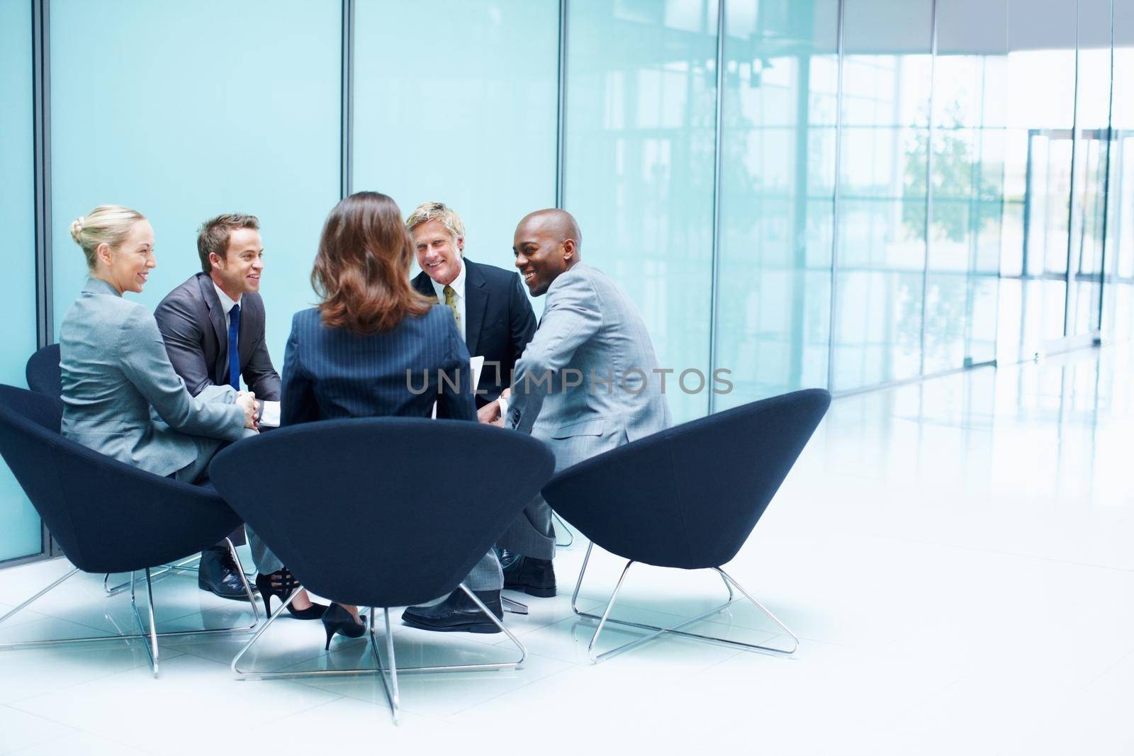 Business people in discussion. Portrait of multi racial business people discussing in meeting. by YuriArcurs