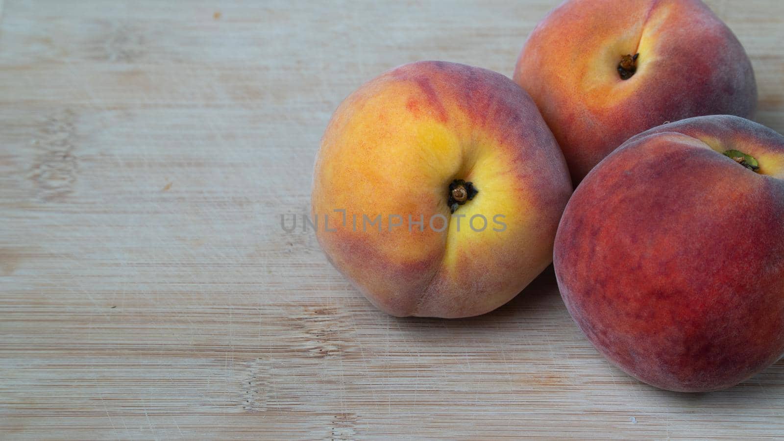 Peach fruits 3 pieces on a wooden background with space for inscription. High quality photo