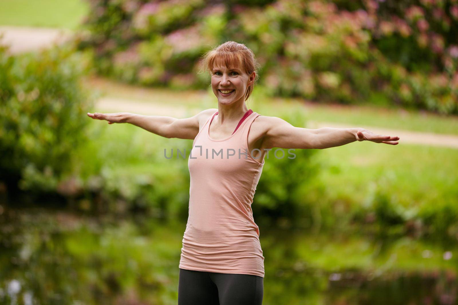 Yoga keeps me healthy and happy. a woman practicing yoga in a park