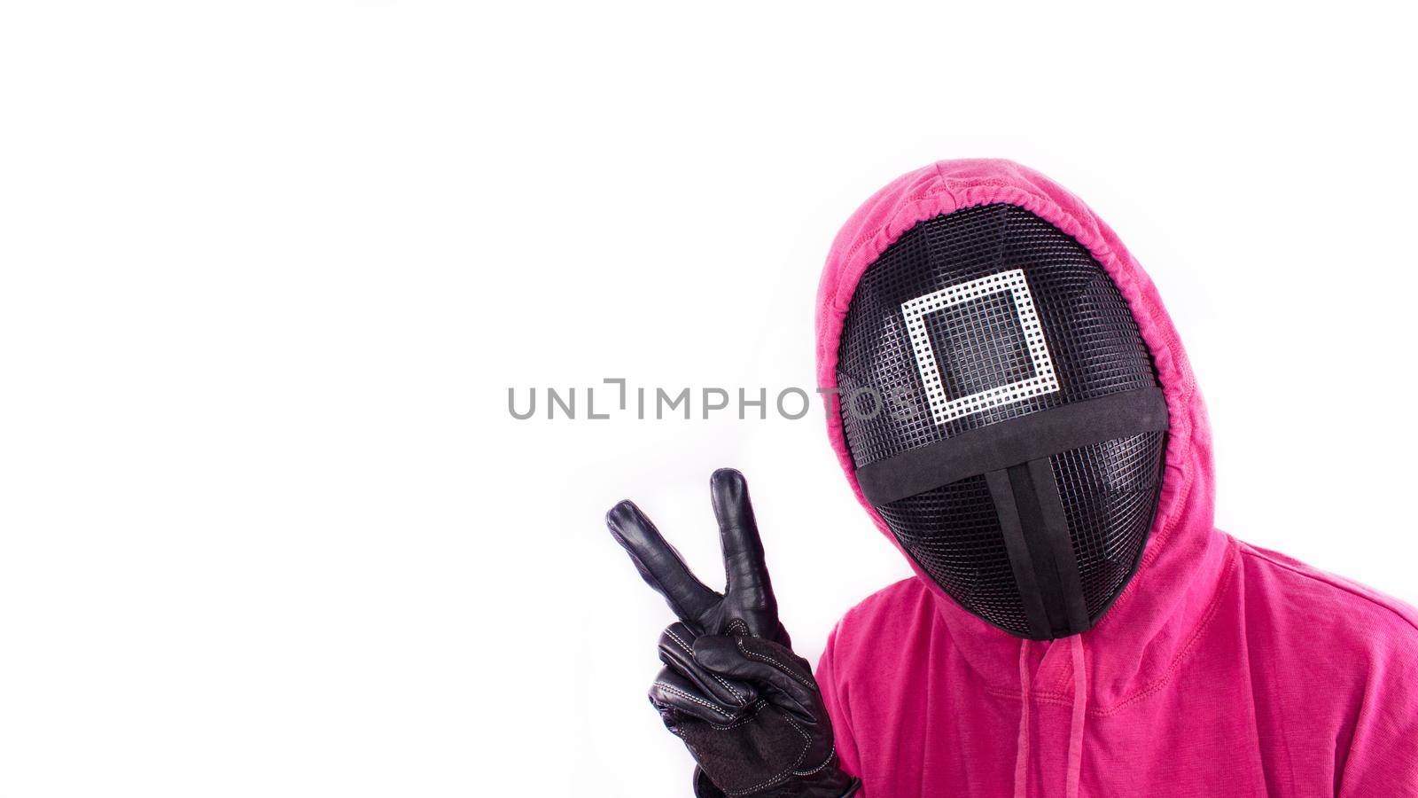 Squid Game red guard with piece sign hand on white background. Space for text. Pink Guard from Squid Game of new Netflix show. South Korean tv series. Gatineau, Quebec Canada - November 2, 2021