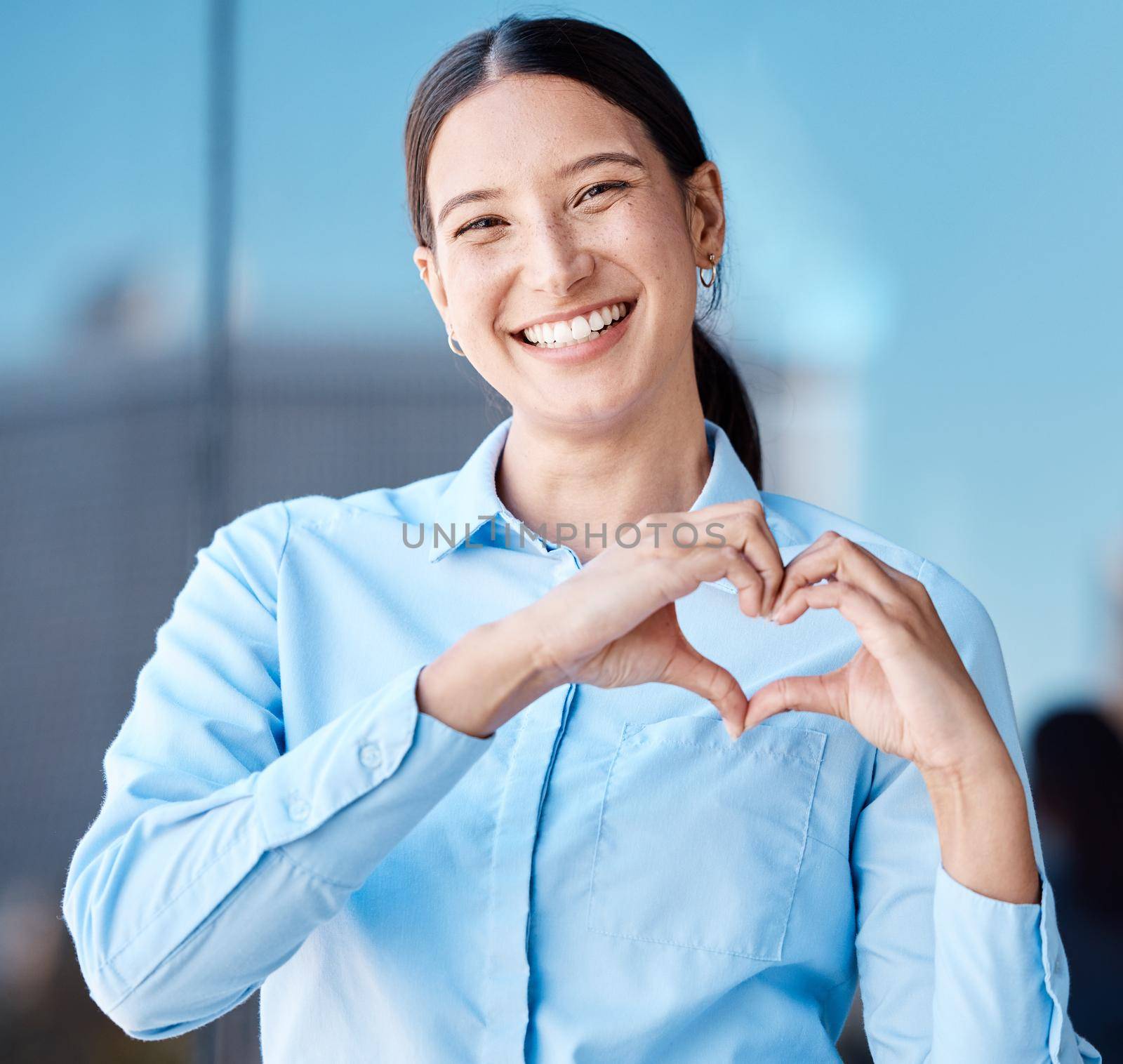 Hands, heart sign and business woman with smile, affection or love emoji. Portrait of happy corporate female, romance or hand symbol or emotion shape, intimacy or adoration, support or affection