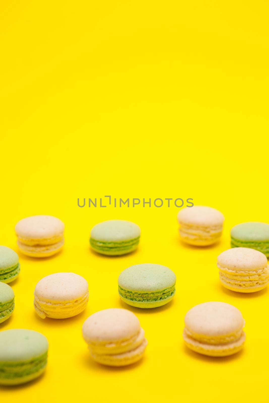Delicious little mint macaroons flavor over yellow background