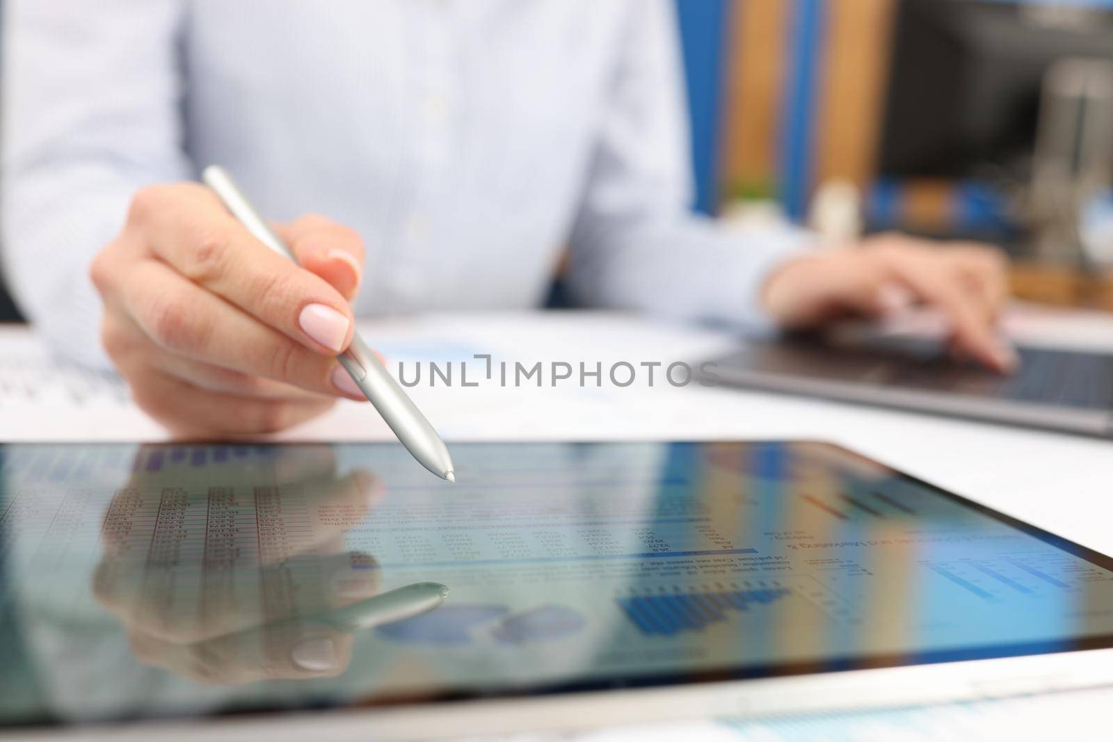 Female hand studying information on digital tablet with stylus closeup by kuprevich