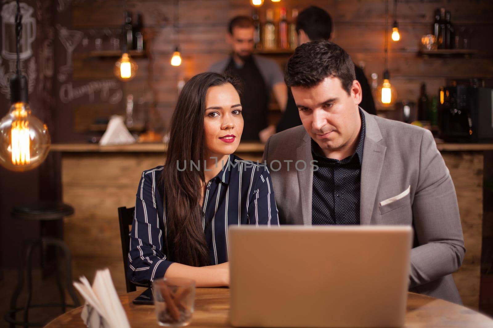 Two business people having a meeting in a coffee shop. Working on laptop. Business talking.