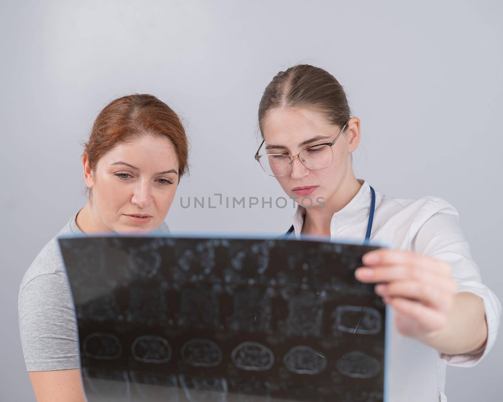 Female doctor explaining mri of internal organs to female patient