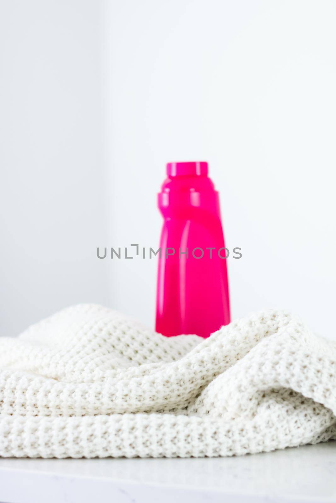 Warm knitted clothes and liquid laundry detergent by Anneleven