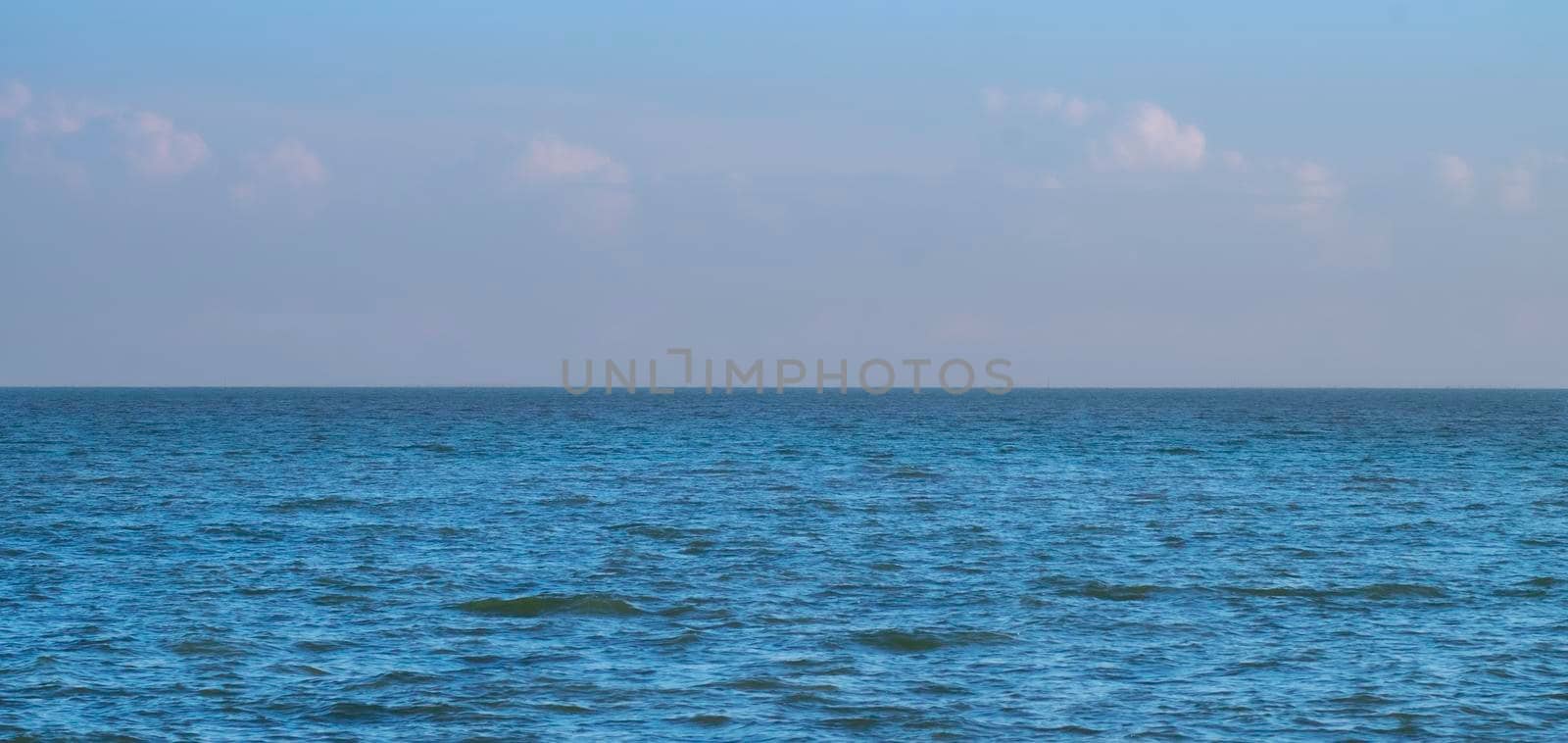 Blue Sea Ocean under blue sky with fluffy white cloud seascape nature background summer travel vacation by Petrichor
