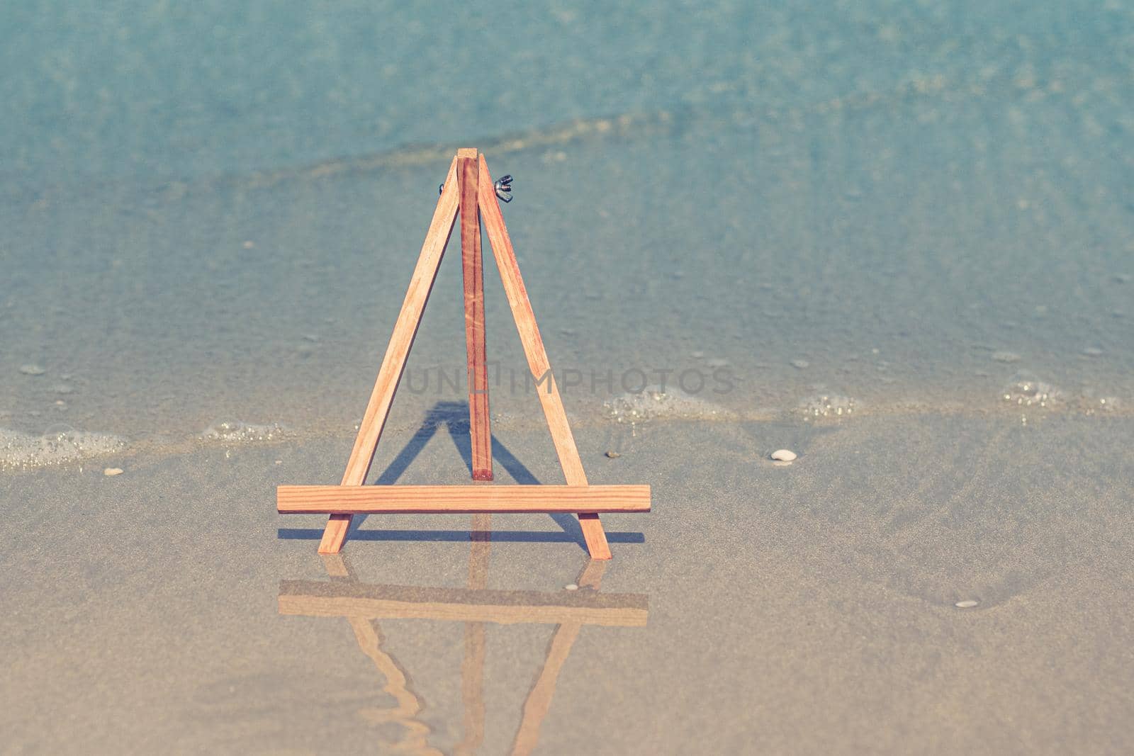 Wooden Easel photo stand tripod for photo with sea on background