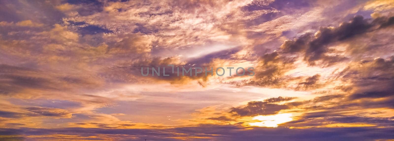 Dramatic sunset sky above clouds.  orange sunset sky. Beautiful sky.Dramatic red yellow pastel color at sunset over the forest by Petrichor