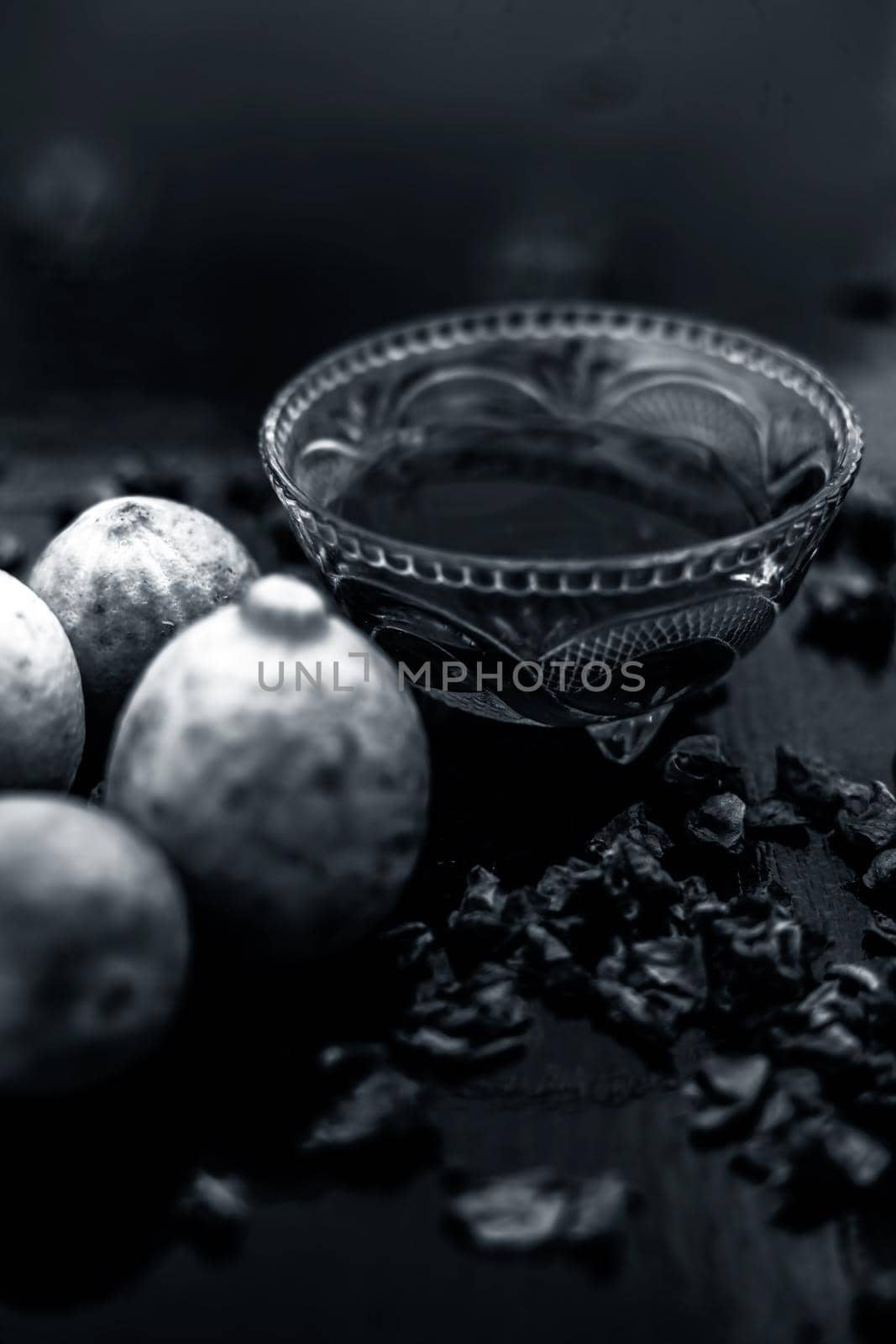 Face mask or pack on wooden surface consisting of rose water, lemon juice for acne and pimple. Vertical shot. by mirzamlk