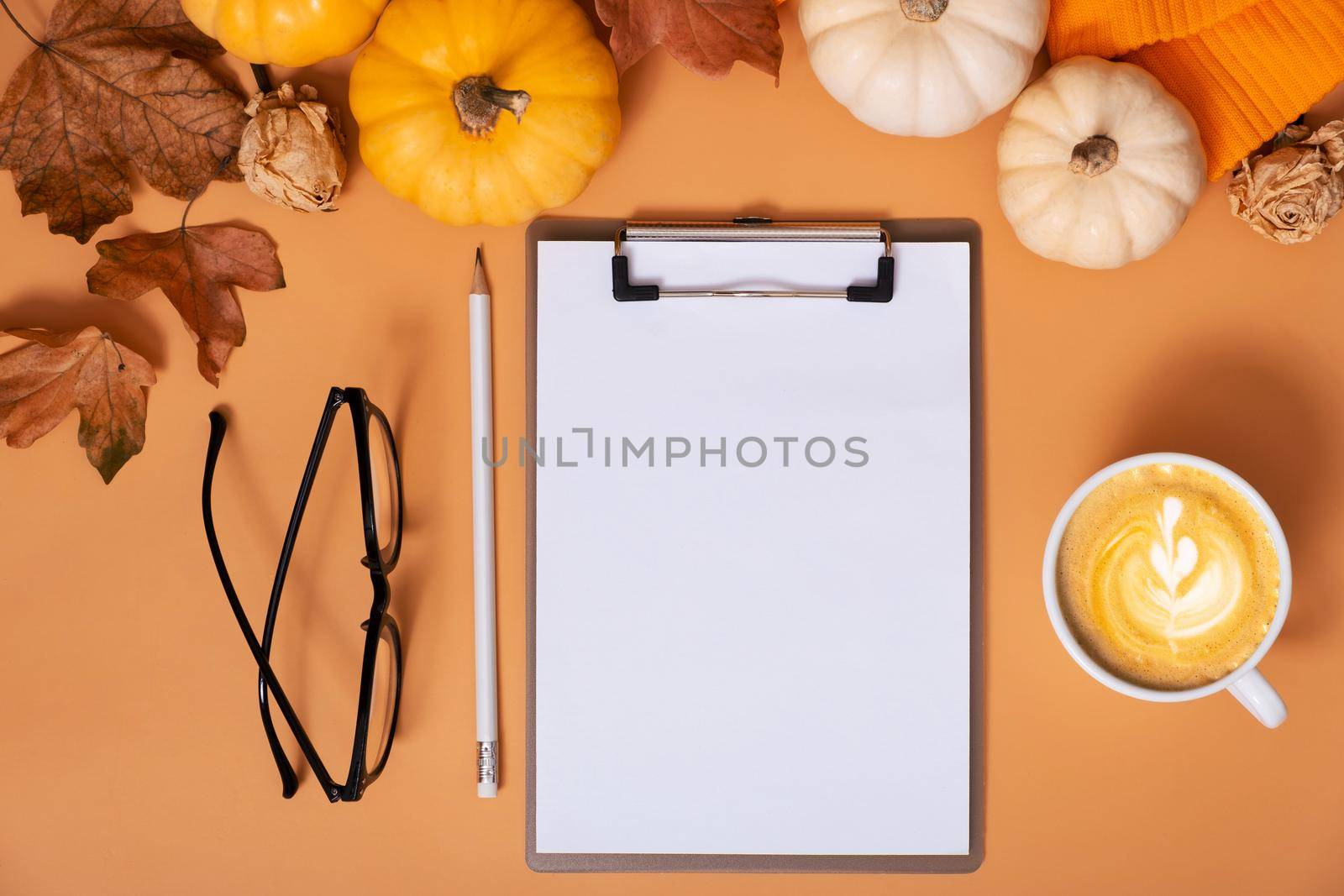 Flat lay blank tablet for text next to pumpkins and autumn leaves with coffee cup. Autumn theme mockup. by ssvimaliss
