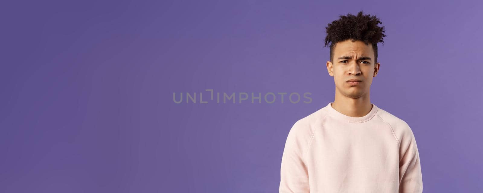 Close-up portrait of skeptical and gloomy, disappointed hispanic young man frowning upset, feel uneasy about bad idea, grimacing with disapproval, standing unhappy purple background by Benzoix