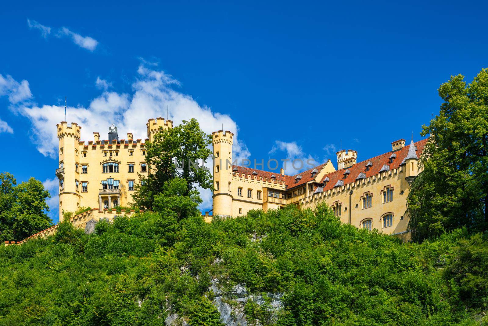 Hohenschwangau Castle near Fussen, Bavaria, Germany. Palace of king Ludwig II in Schwangau village. Schloss Hohenschwangau is landmark of German Alps. Hohenschwangau Castle and Alpsee in Schwangau.